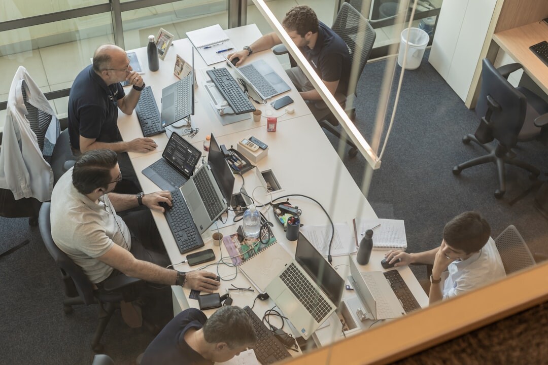 Technology professionals working on analytics screens in a modern office